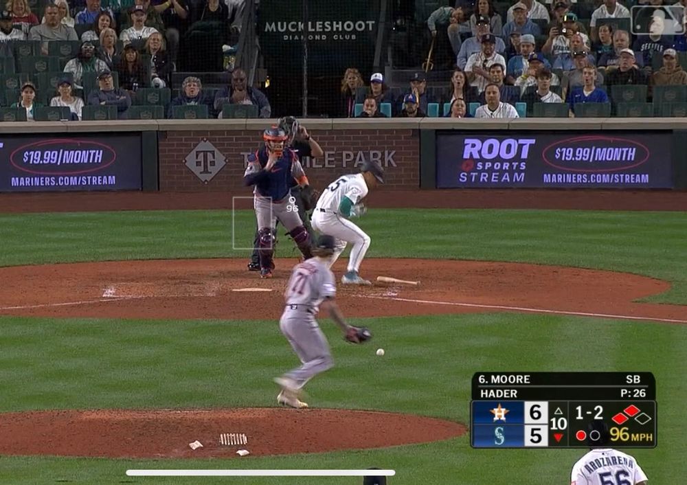 Dylan Moore hunches over in agony after being hit by a pitch