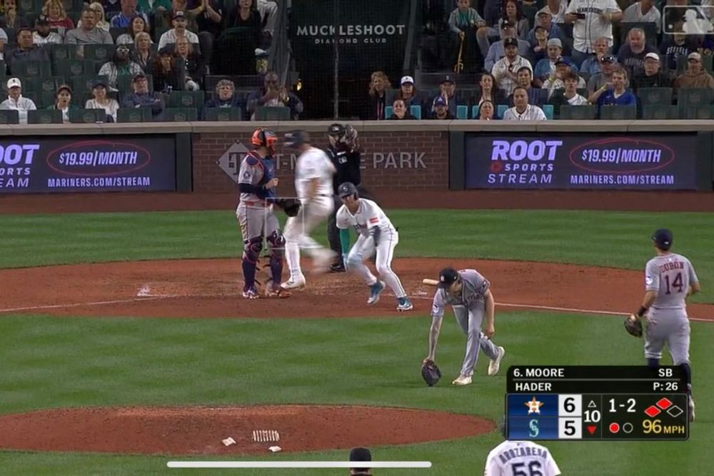 Dylan Moore hunched over in pain still while Cal Raleigh scores and Josh Hader unhurriedly picks up the baseball