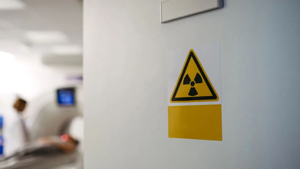 Radioactive sign on door of CT scanner room