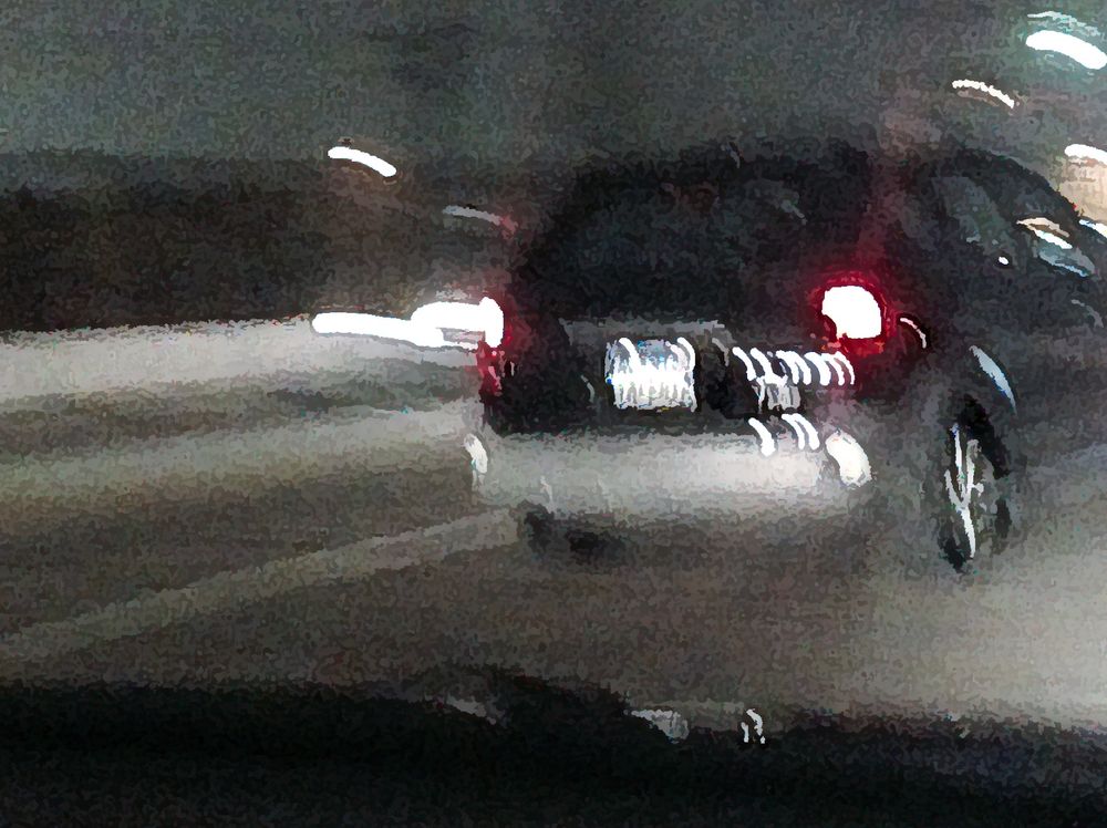 ICM image of an SUV at night with light streaks, from the POV from another vehicle