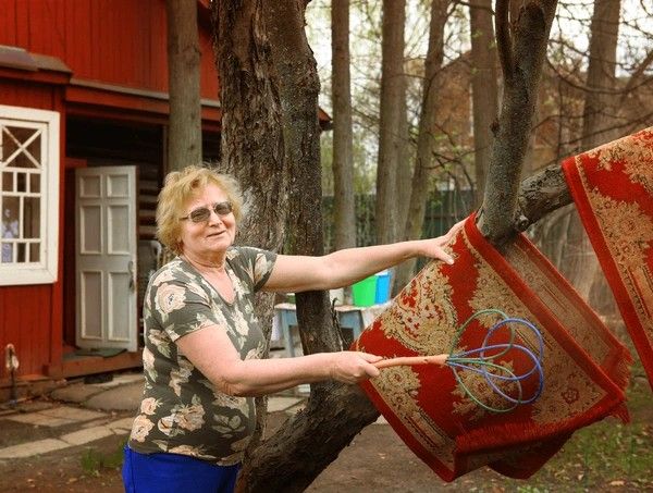 A photo of an older woman beating a rug. Smack that shit, meemaw.