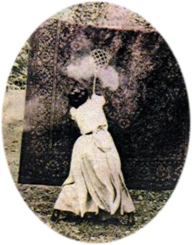 Black and white photo of a lady hitting the shit out of a rug