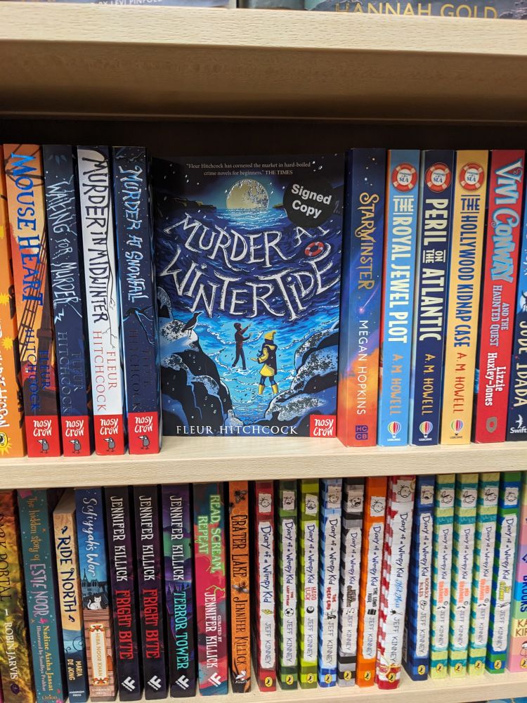 Murder at Wintertide face out in Hunting Raven bookshop. Alongside other titles from the same author.