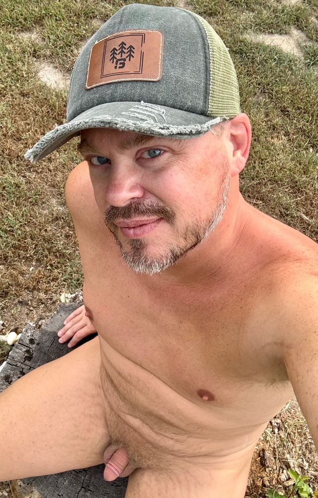 Myself, sitting nude on a stump, wearing only a hat. 