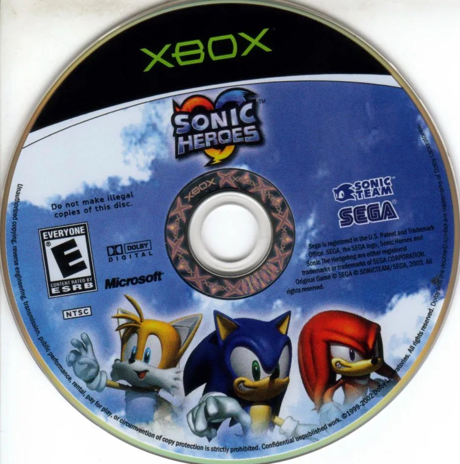 Disc art for the Xbox NTSC-U release of Sonic Heroes. It's the Sonic Heroes logo on the top, with Sonic, Tails and Knuckles striking a pose plastered on top of a stock photo of some clouds.