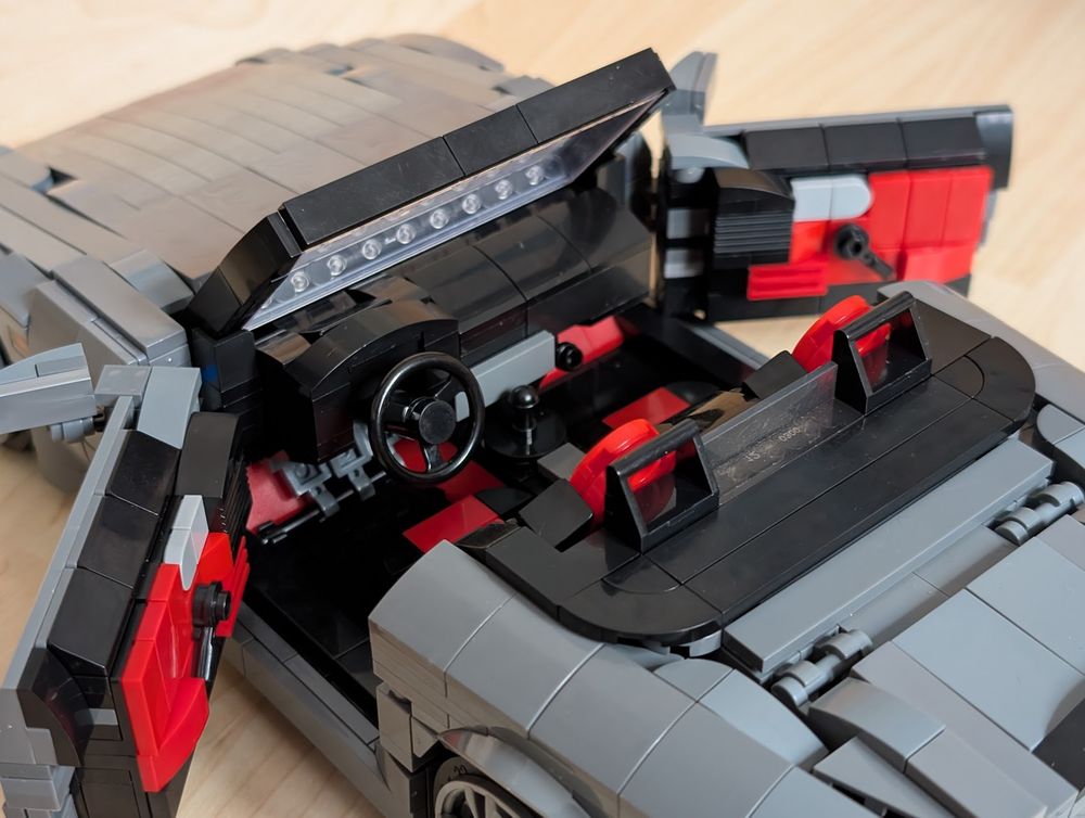 A Lego-built grey Honda S2000 with doors open, showing the interior.