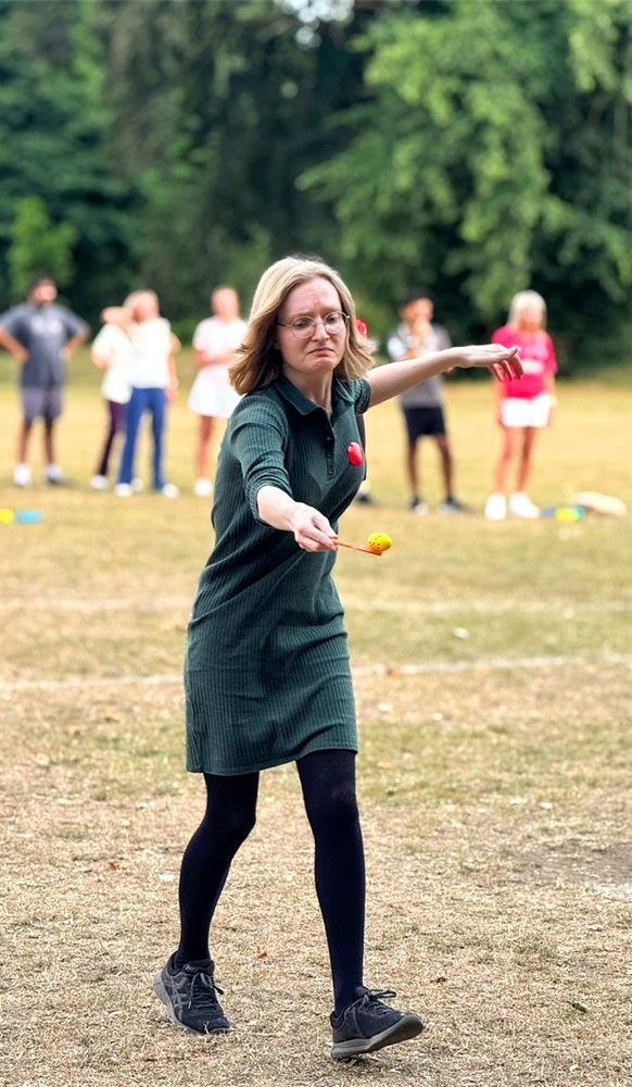 photo of me in a dress and tights doing an egg and spoon race. i am not having a good time