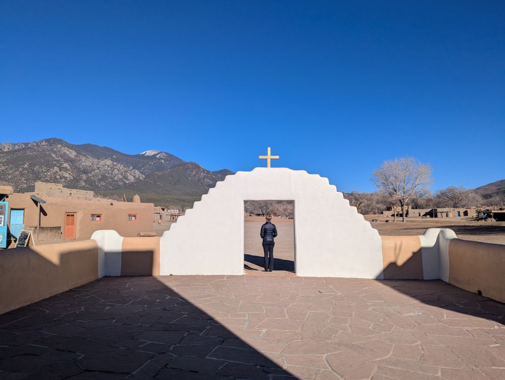 My wife standing under the arch at Taos Pueblo