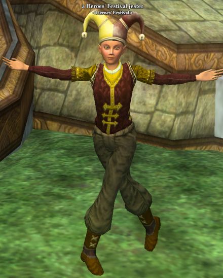 A human from the mmo game EverQuest 2. The NPC wears a red, gold and brown outfit and has a red and yellow jester hat on their head. Their name is above them in white writing; a Heroes Festival Jester. 