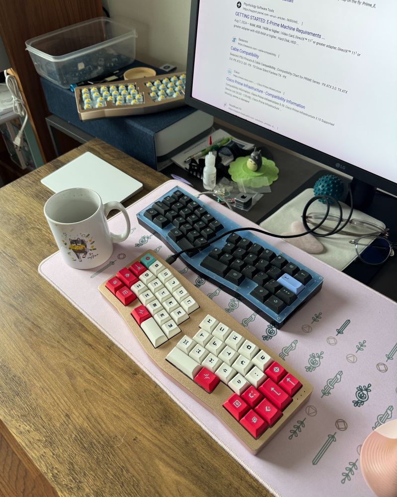 Candid desk shot with 3 of the same weird keyboard while one is being debugged for firmware not working.