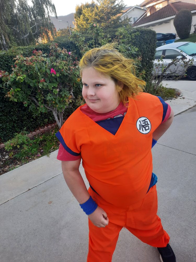 Child in goku outfit with hair swept back