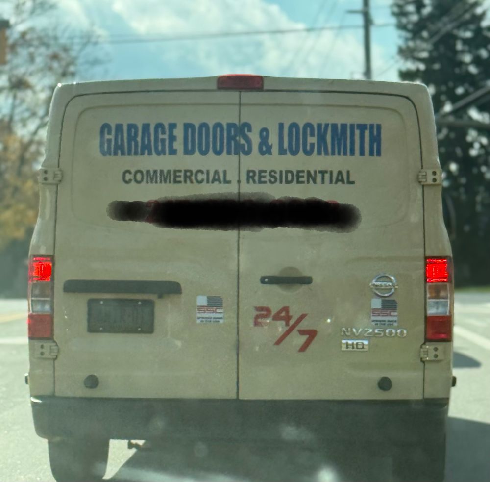 Photo of service van that reads GARAGE DOORS & LOCKMITH, instead of LOCKSMITH