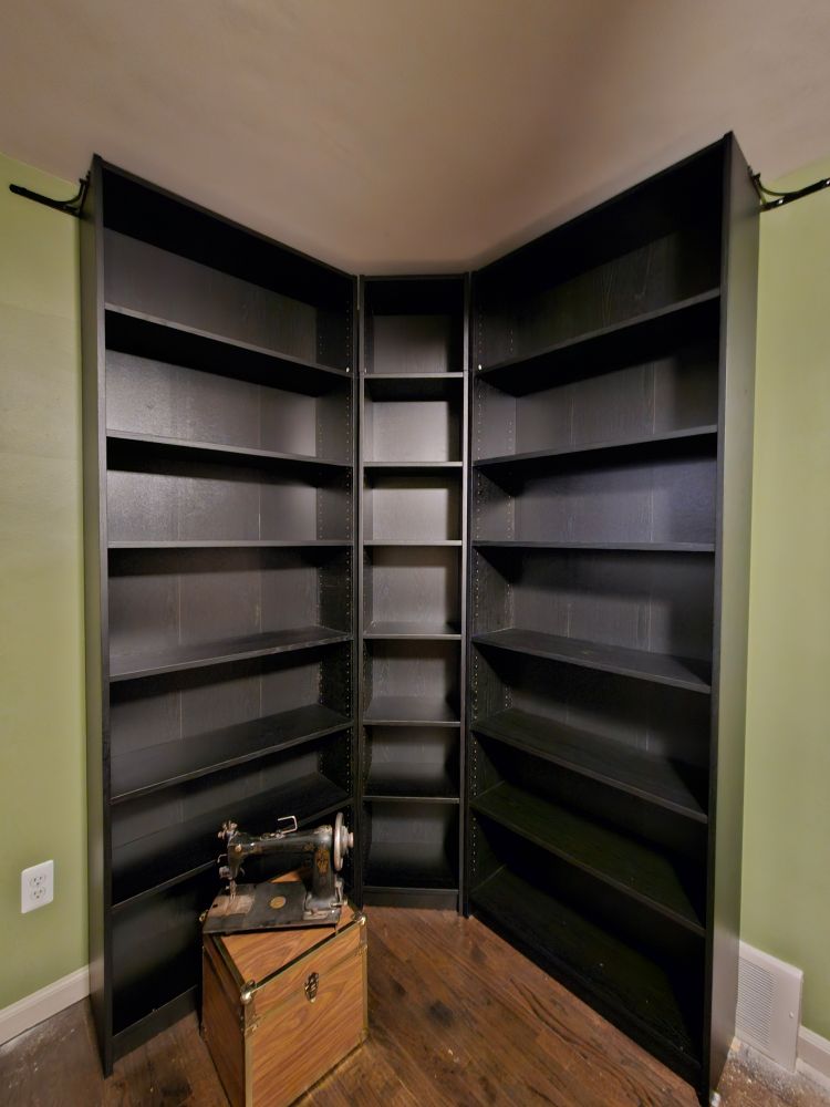 View of the bookshelf in fisheye to get the whole thing in the frame, before I cleaned up all the dust and moved the sewing machine and file box to their new home
