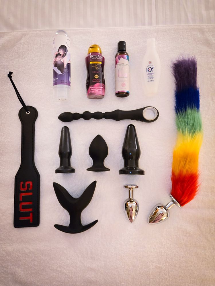 Collection of various anal pugs, a paddle and lubes. The plugs  include a tail, jewel plugs and stretching set. 