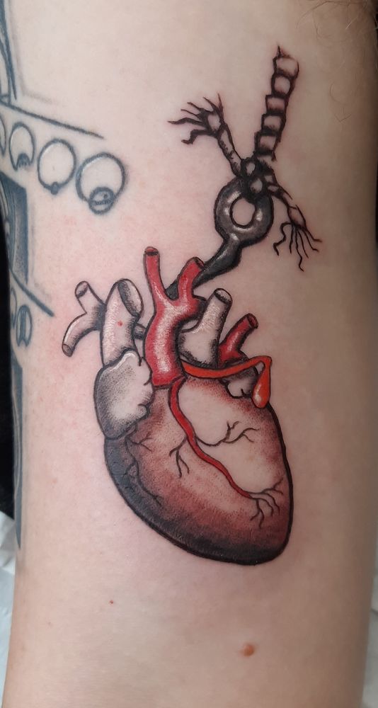 Tattoo of a heart on a meat hook 