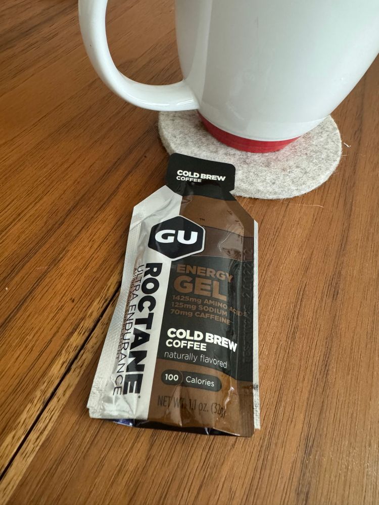 Cold Brew Coffee gu energy gel next to a cup of coffee