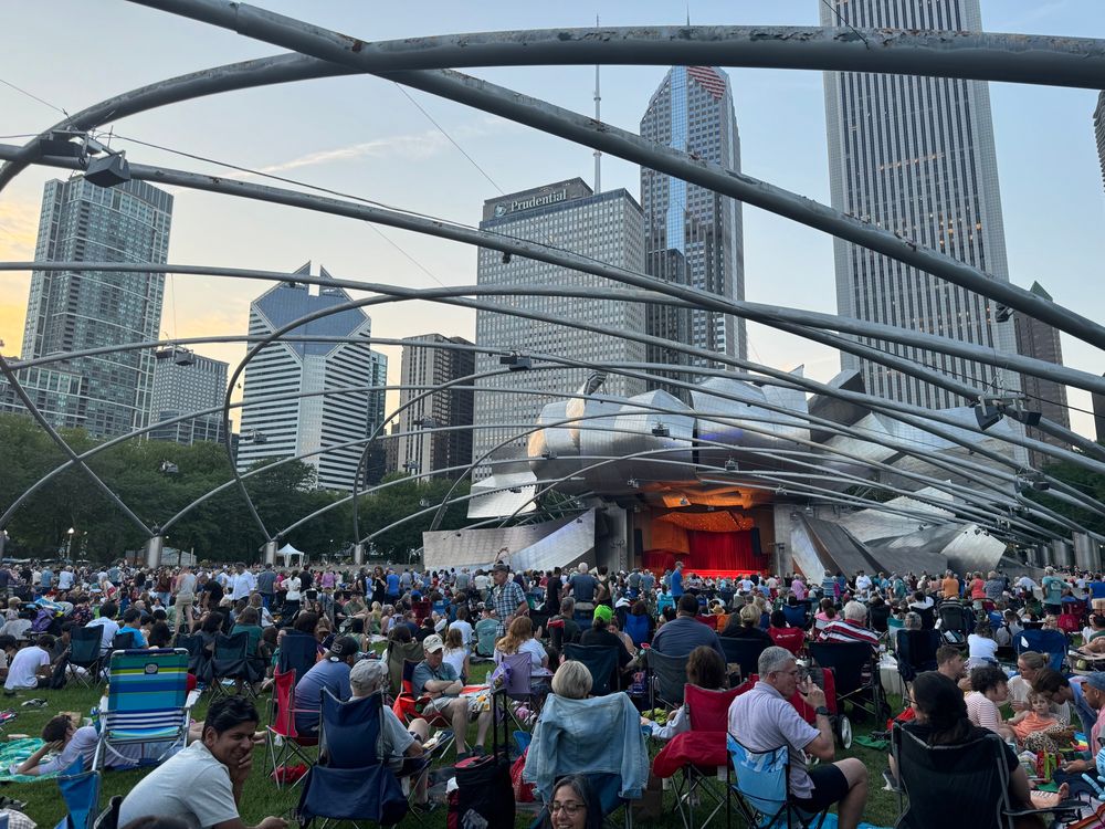 Prtizker Pavilion during Grant Park Music Series with a huge crowd and the Chicago skyline in the background