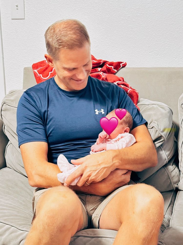 Cameron holding his granddaughter on his lap