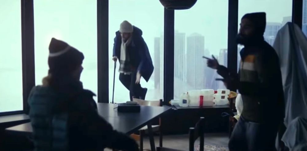 Scene from Station Eleven with three people dancing in a high rise apartment 