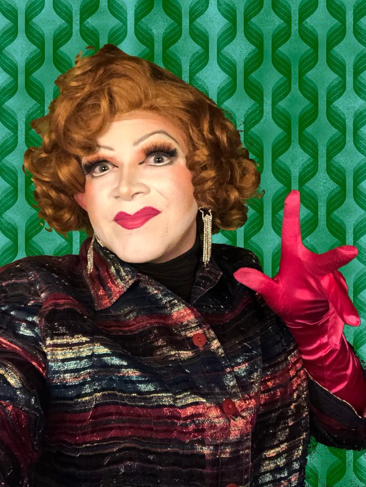 Kitten in a striped blazer with pink gloves