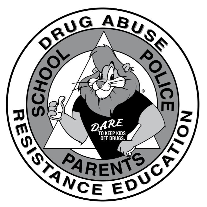 A black and white logo for the Drug Abuse Resistance Education (D.A.R.E.) program. The logo is circular with a thick outer ring containing text. The top half of the ring reads "DRUG ABUSE" and the bottom half reads "RESISTANCE EDUCATION." Inside the ring, a stylized cartoon lion is giving a thumbs-up. He is wearing a black t-shirt that says "D.A.R.E. TO KEEP KIDS OFF DRUGS." 
