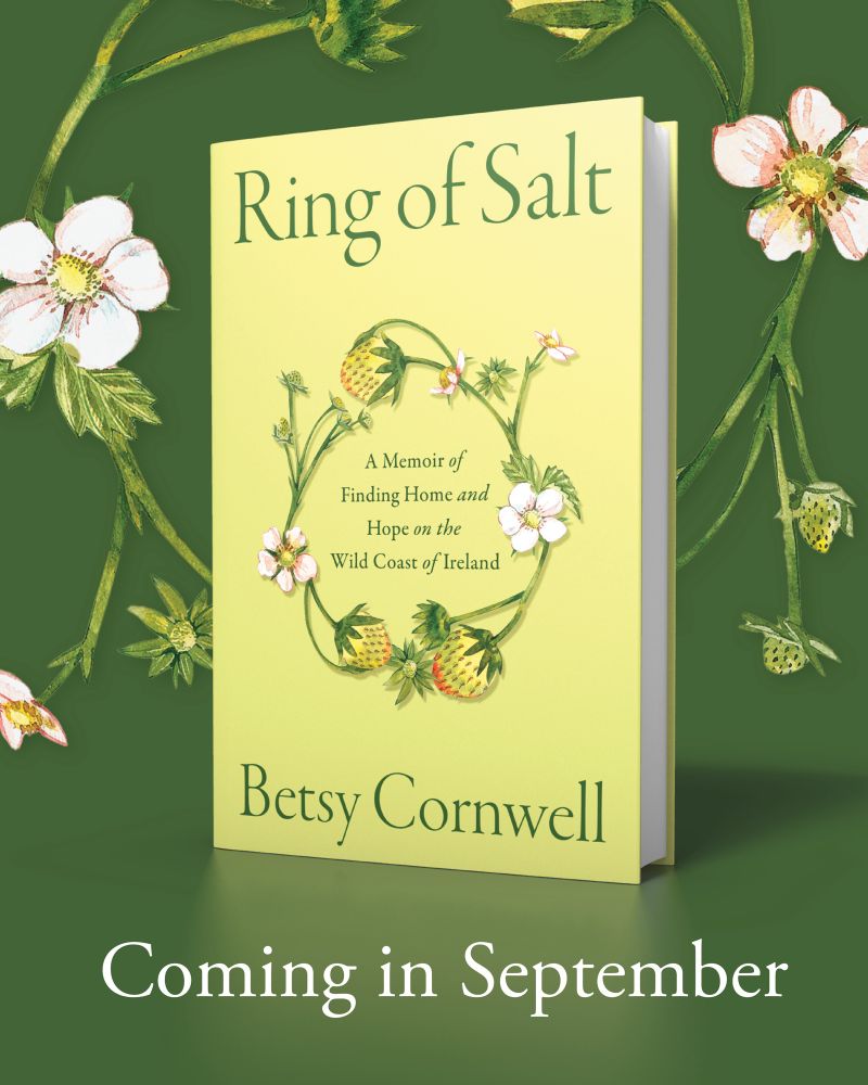 A digital image of a pale green hardcover book, illustrated with a ring of wild strawberry leaves, blossoms, and fruit, on a darker green background with the same illustrations. The book is Ring of Salt: A Memoir of Finding Home and Hope on the Wild Coast of Ireland by Betsy Cornwell. Below the book in white letters is “Coming in September”