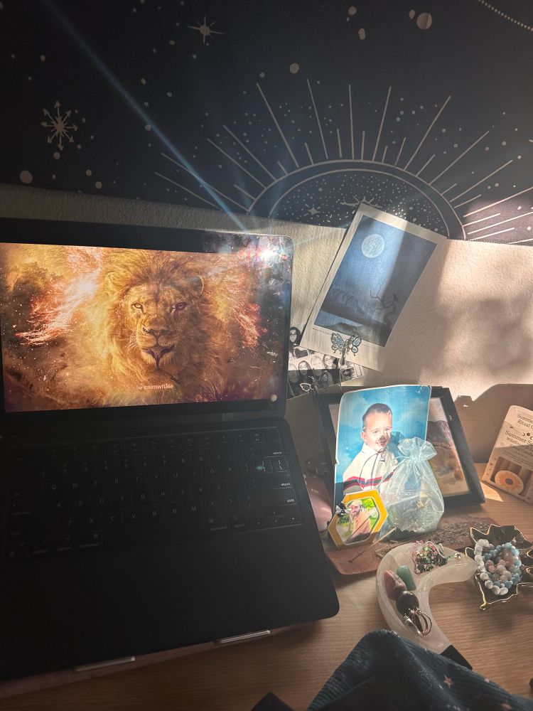 Lion’s Gate energy on Seri’s desk with crystals, photos and incense 