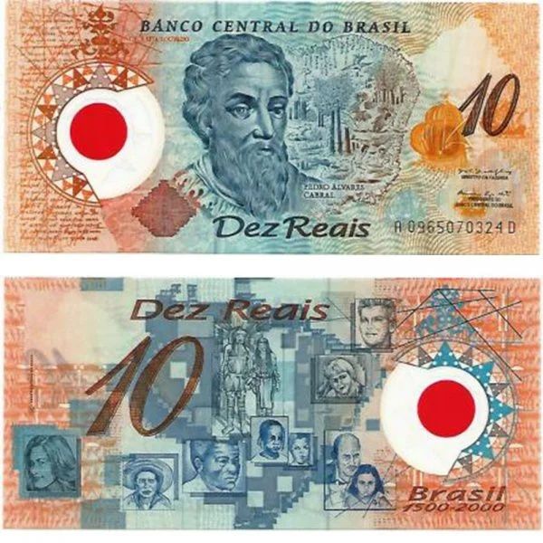 nota de dez reais antiga, com o rosto de pedro álvares cabral e uma pequena esfera vermelha de plástico 