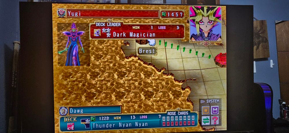 Photo of a TV Screen with Yu GI Oh Duelist of the Roses on it 
