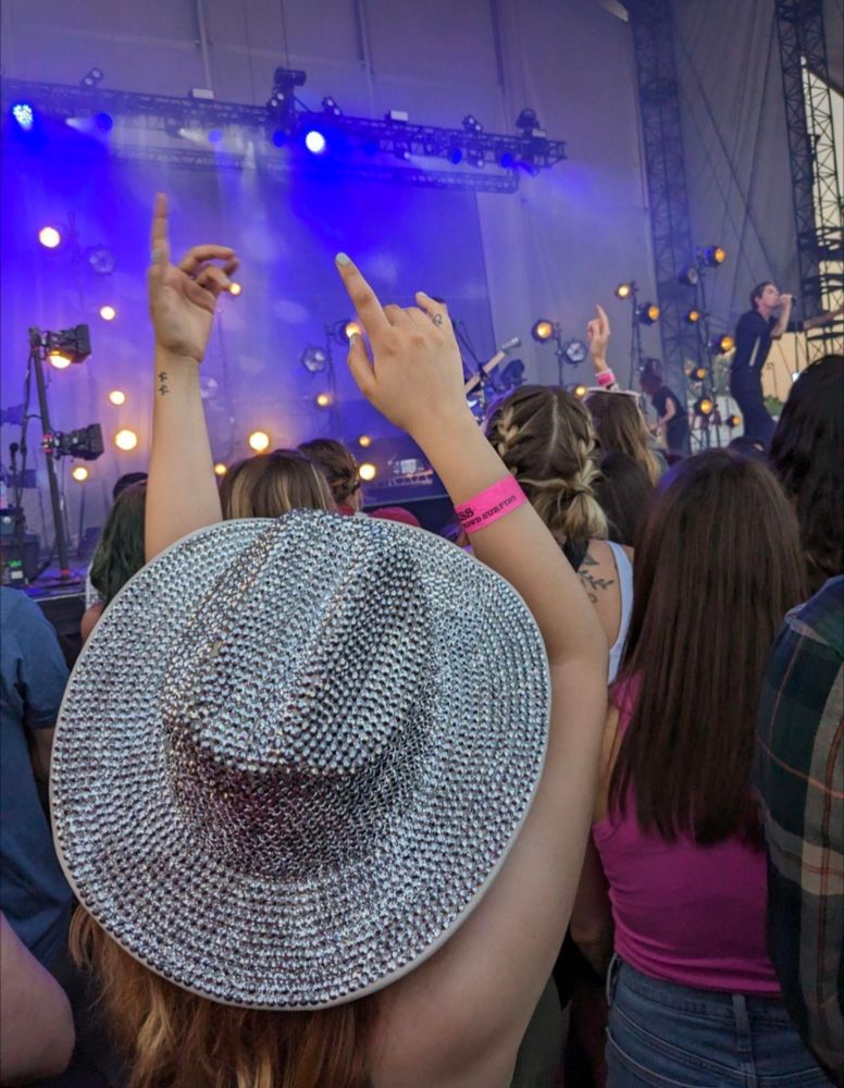 Me watching the Maine at sad summer fest wearing a super sparkly cowboy hat