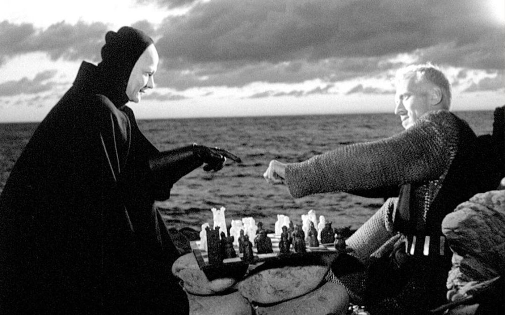 Ingmar Bergman, The Seventh Seal.
The knight offers Death to pick a hand that will decide who plays black or white in a game of chess during the black death pandemic.