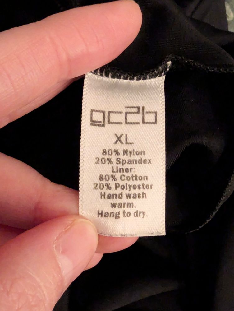 The label of the binder showing size XL and materials - nylon, spandex, cotton and polyester. 