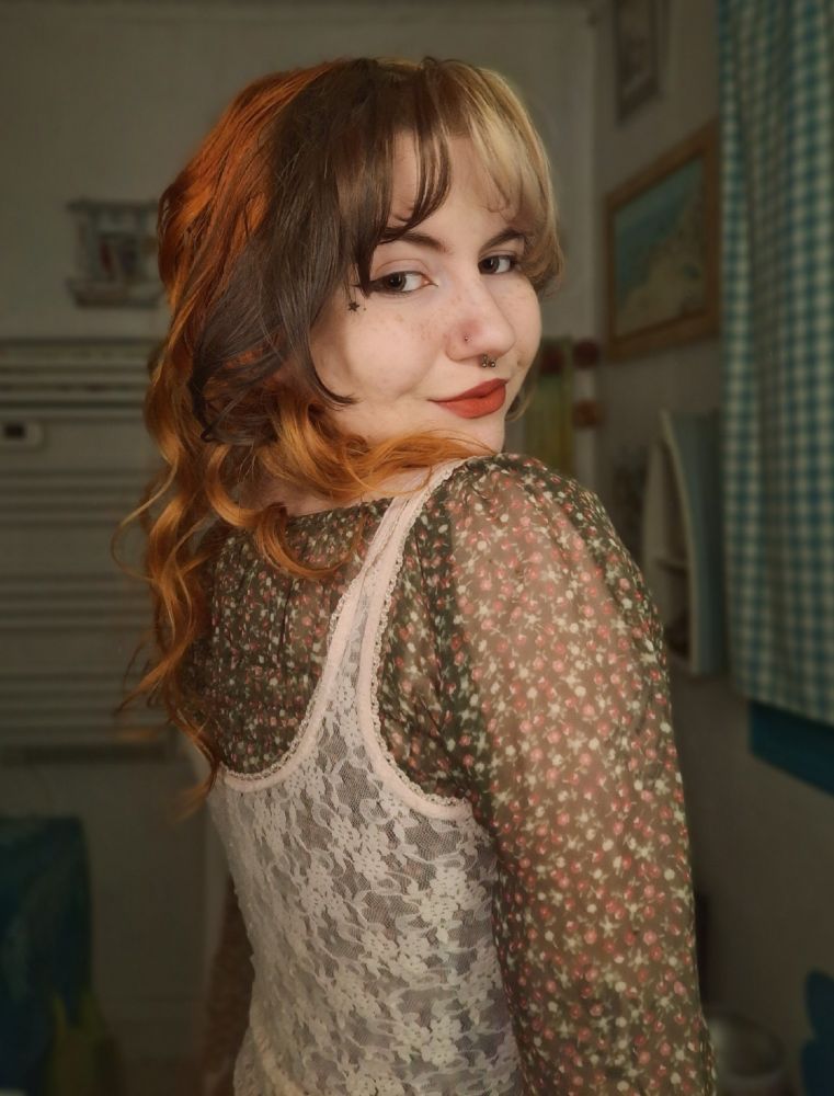 Photo de moi portant un haut vert à fleurs roses, un haut corset rose par dessus, et une cravate marron