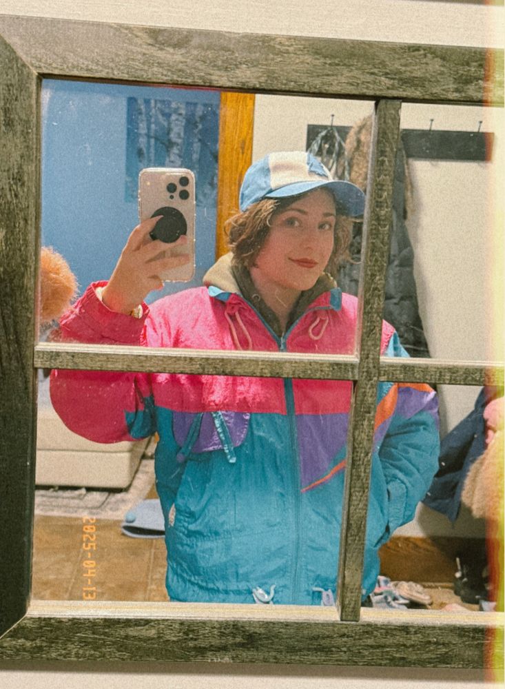 mirror selfie before going out to pick up my adhd medication. im wearing a big hoodie under a vintage neon 90s windbreaker and a dipper pines hat 