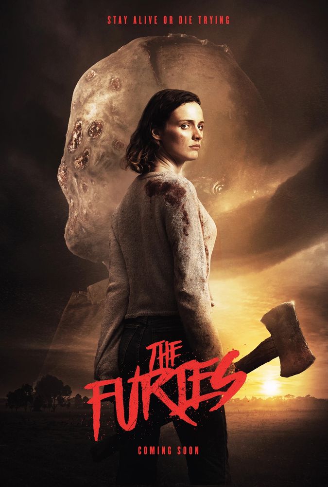 Movie poster for The Furies - a woman stands with her back facing away from the camera. She is turning her head towards us. She is holding an ax.
