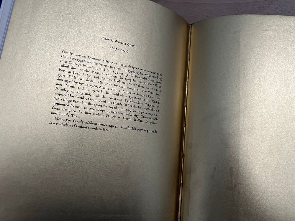 A short biography of Frederic Gouda printed on metallic gold paper.