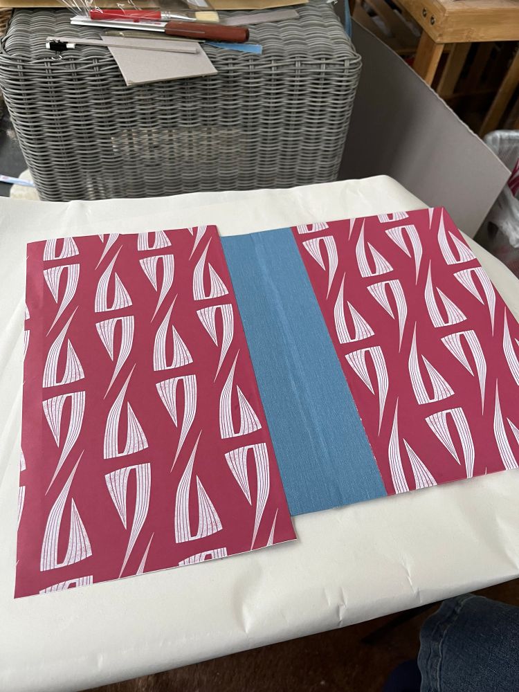 Outside view of the case with both papers stuck down but only one side folded over.