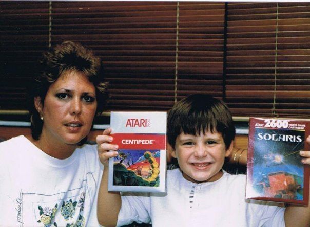 Myself and my mother, circa 1989.  I have been gifted copies of Centipede and Solaris to play on a newly acquired Atari 7800.  I am 7 years old.  I am ecstatic.  