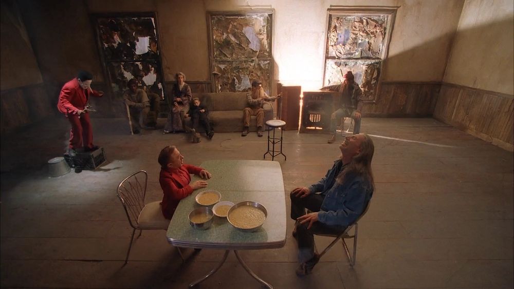 The convenience store scene from Twin Peaks: Fire Walk With Me; depicting several odd looking people in a run down room.  Bowls of creamed corn on a Formica table.  Hey.