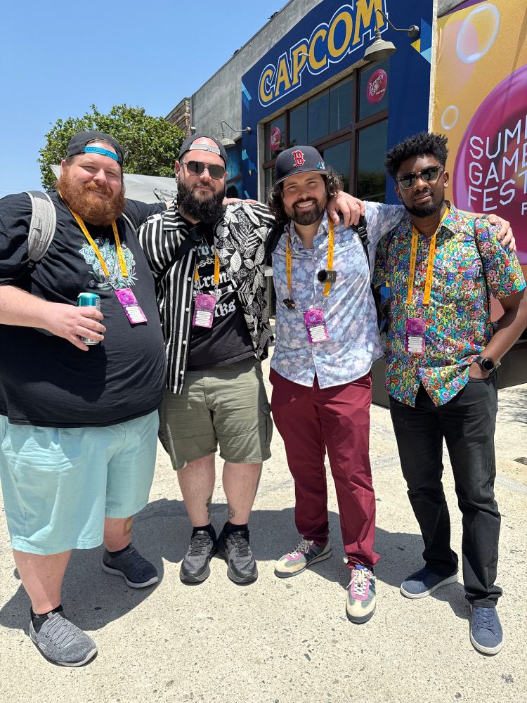 Kyle and Mike from Six One Indie with Brenden and Mike from Pass The Controller standing in front of Capcom 
