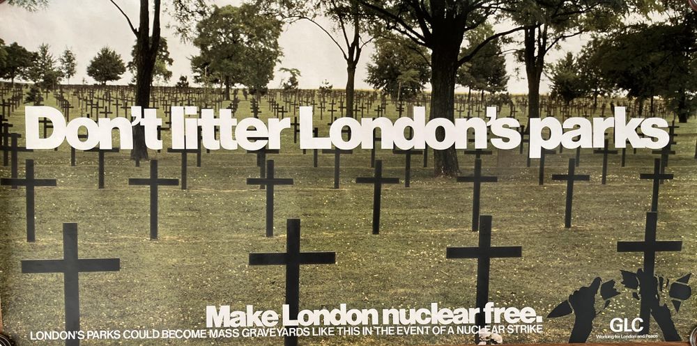 The poster features an image of rows of graves marked by crosses in a London part.  The text reads: “Don't litter London's parks
Make London nuclear free.
LONDON'S PARKS COULD BECOME MASS GRAVEYARDS LIKE THIS IN THE EVENT OF A NUCLEAR STRIKE”