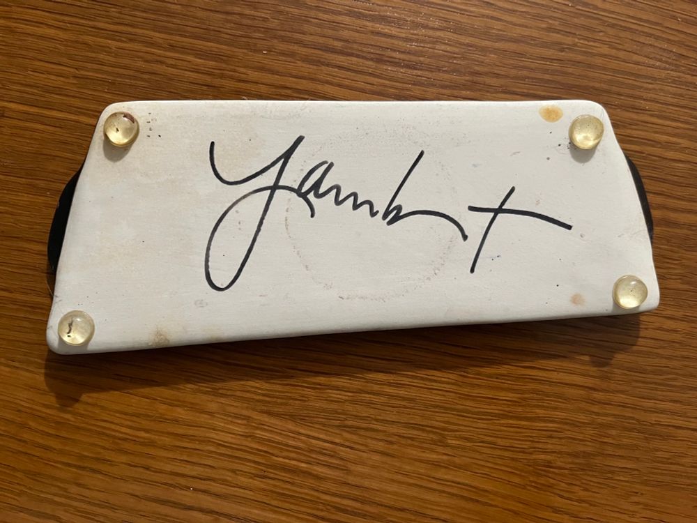 Bottom side of asymmetrical pottery tray for salt & pepper set; unglazed; signed in script, maybe Jarmbert? 