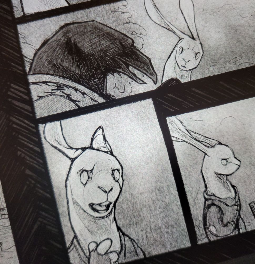 A closeup of three panels of a comic in progress. It's sketched in a black and white ballpoint pen mark with greytones. The panels feature rabbit and raven characters. 