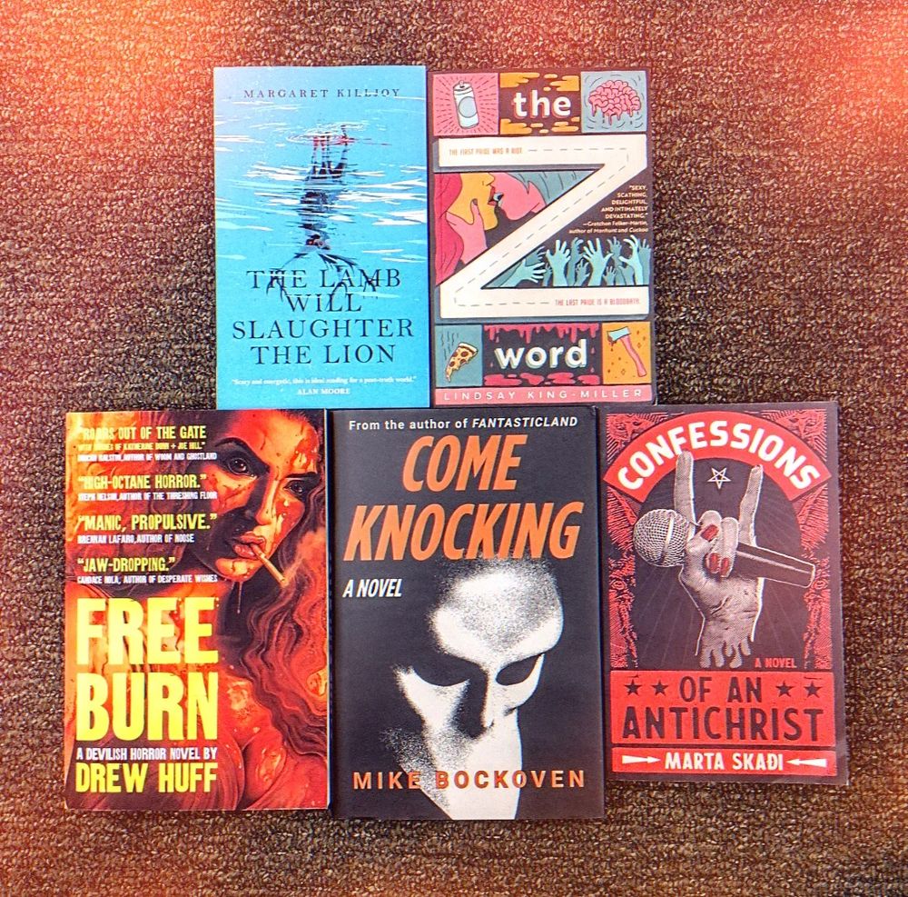 an array of horror books on a carpeted floor