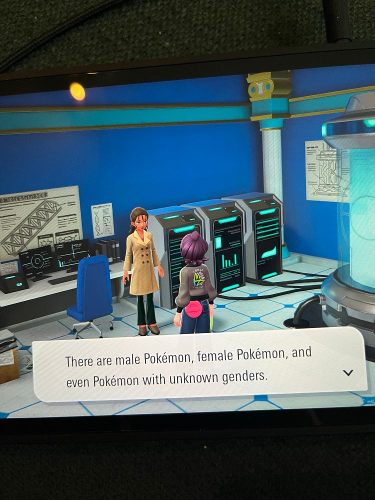 Photo of a Switch screen with two characters talking and one saying “There are male Pokémon, female Pokémon, and even Pokémon with unknown genders.”
