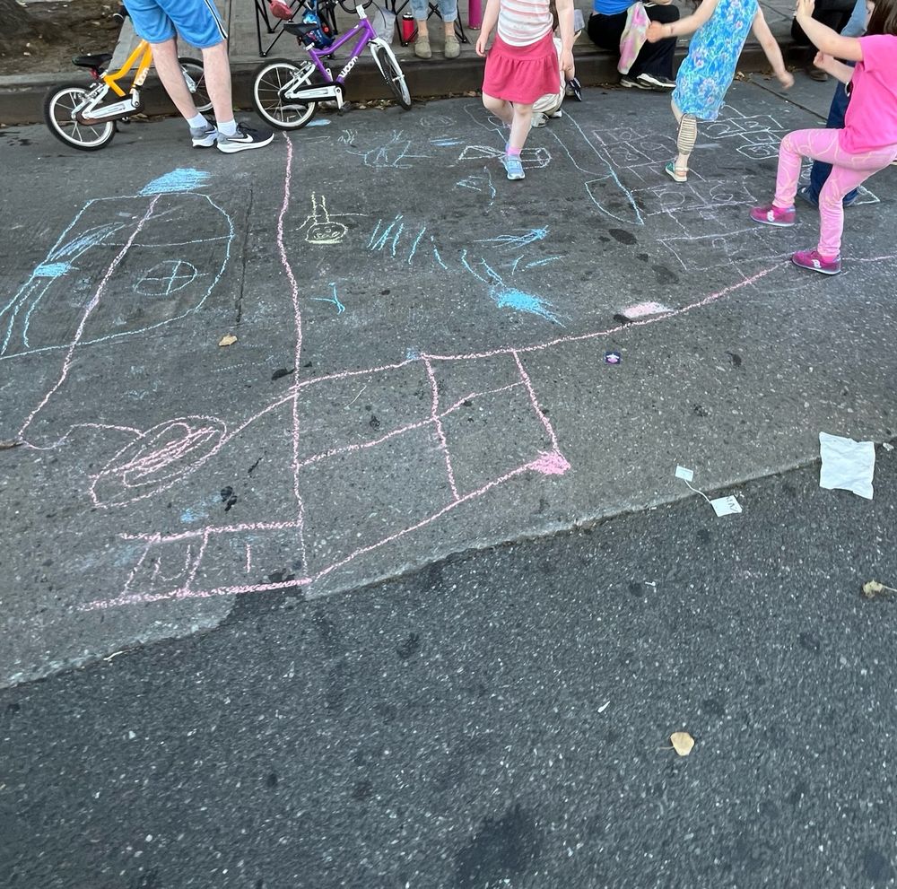 Kid’s chalk markings on pavement. 