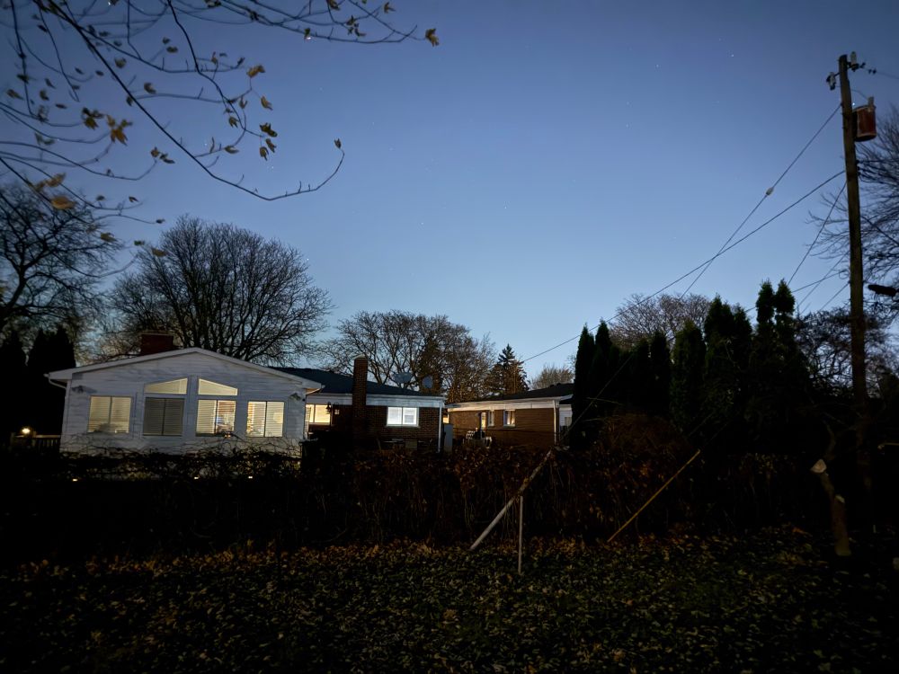 Night sky with a house in the foreground.