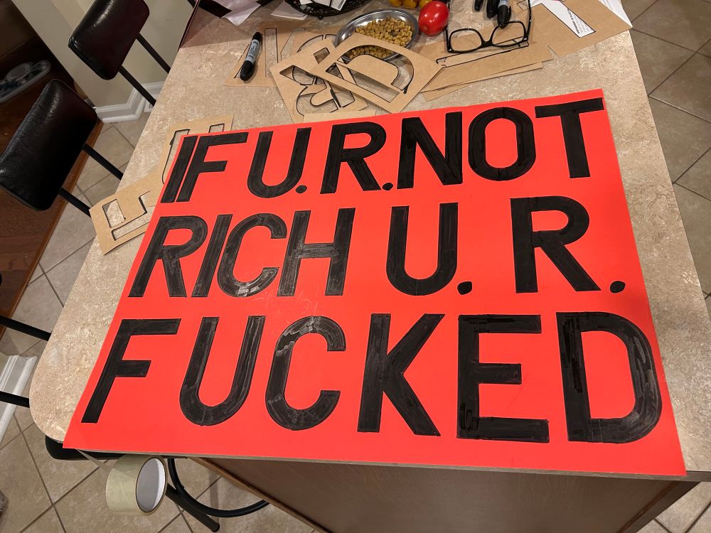 Protest sign pointing out that if you are not rich you are fucked