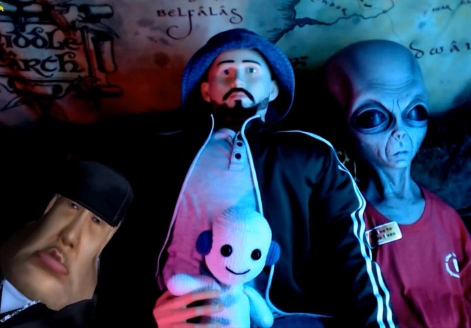 Vinesauce stream ending scene showing various characters sitting on a couch. Going from left to right: Eggplant, Vinny mannequin holding a chat plush, and Gnorts.