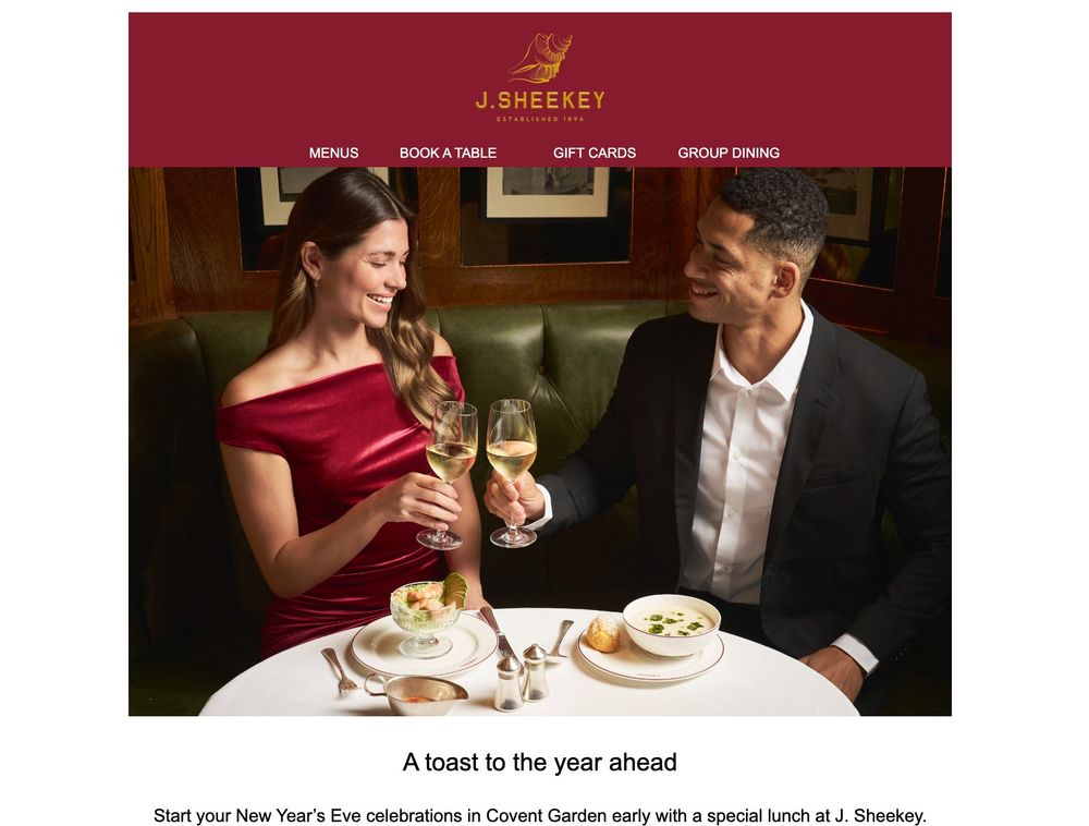 A man and a woman at a table at J Sheekey restaurant share a glass of wine. But not a snog, unlike Michael Gove.